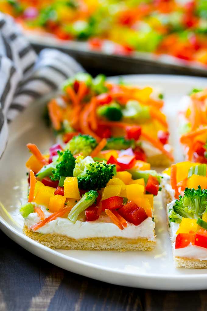 Veggie Pizza Recipe | Crescent Veggie Pizza | Vegetable Pizza Recipe | Holiday Appetizer | Homemade Veggie Pizza #pizza #veggies #vegetarian #appetizer #sraye Slices of veggie pizza on a serving plate.