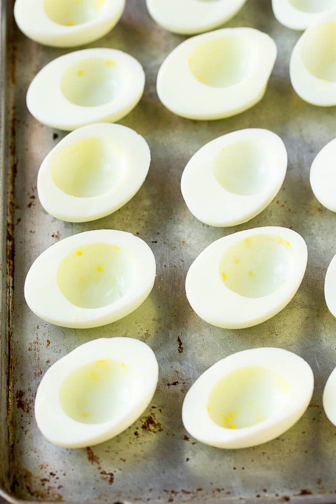 Bacon Deviled Eggs | Deviled Eggs Recipe #eggs #keto #lowcarb #bacon #appetizer #sraye Egg white halves on a sheet pan.