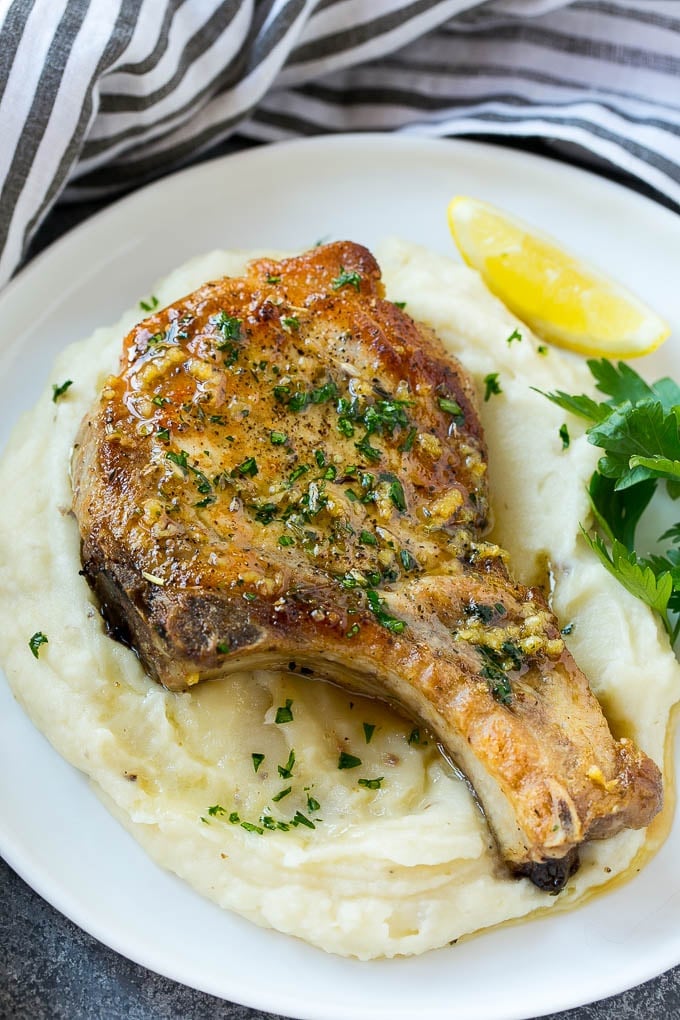 Brown Sugar Pork Chops Recipe | Bone In Pork Chops Recipe | Garlic Butter Pork Chops | Skillet Pork Chops #pork #porkchops #garlic #dinner #glutenfree #sraye Brown sugar pork chops on a bed of mashed potatoes.