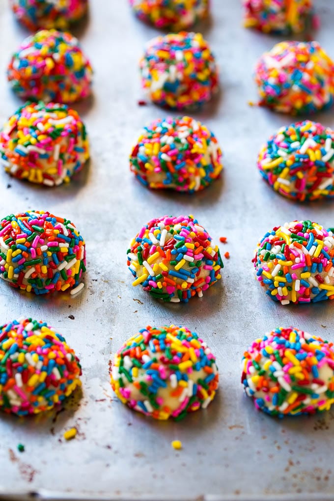 Funfetti Cookies Recipe | Funfetti Cake Mix Cookies | Sprinkle Cookies | Cake Mix Cookies #cookies #funfetti #sprinkles #dessert #sraye Balls of cookie dough coated in sprinkles.