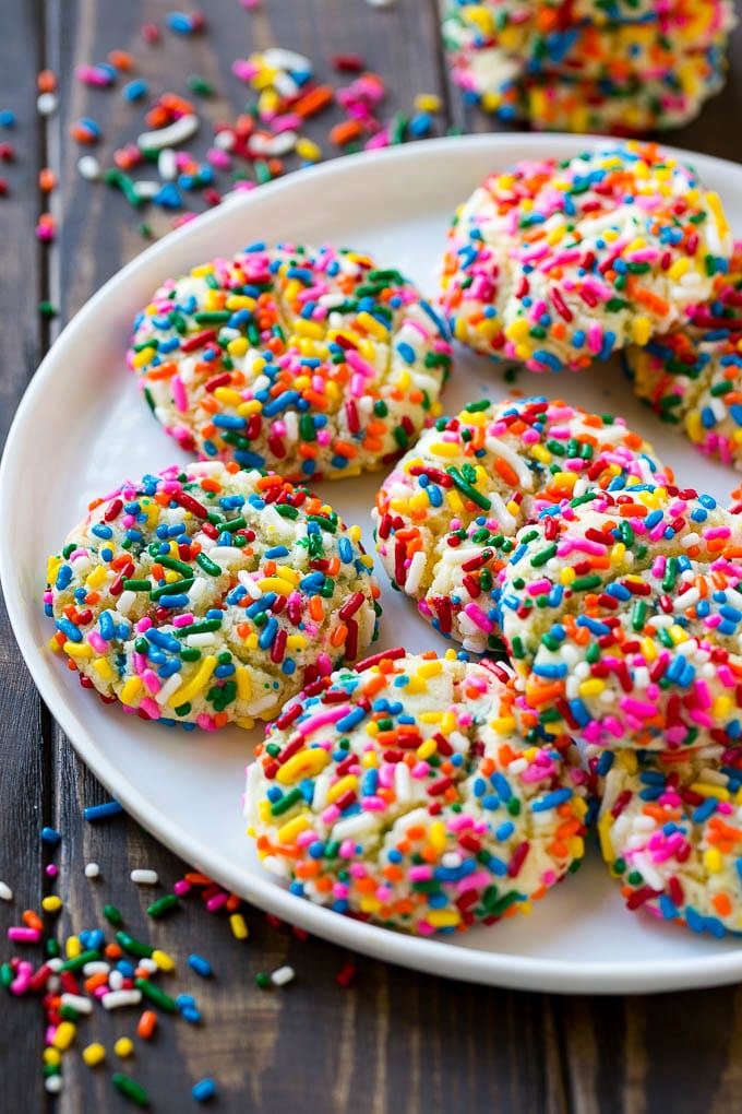 Funfetti Cookies Recipe | Funfetti Cake Mix Cookies | Sprinkle Cookies | Cake Mix Cookies #cookies #funfetti #sprinkles #dessert #sraye A plate of funfetti cookies coverd in rainbow sprinkles.