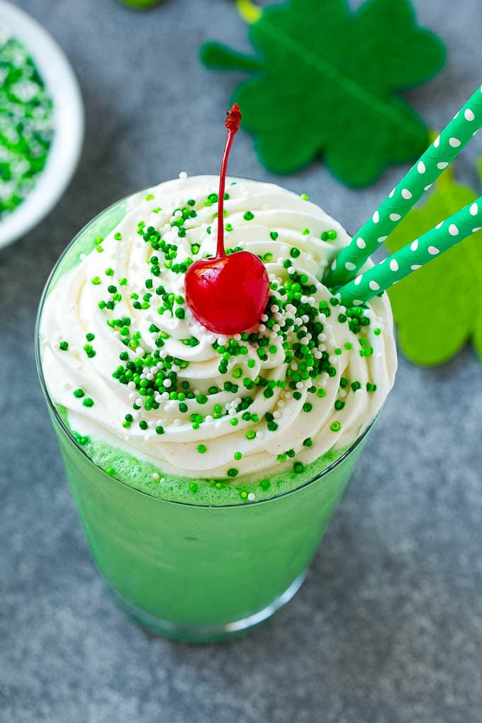 Shamrock Shake Recipe | McDonald's Shamrock Shake | Saint Patrick's Day Drink | Mint Milkshake #milkshake #stpatricksday #saintpatricksday #mint #sraye A mint Shamrock shake finished off with a swirl of whipped cream sprinkles and a cherry.