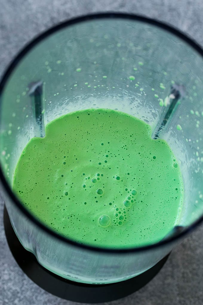 Shamrock Shake Recipe | McDonald's Shamrock Shake | Saint Patrick's Day Drink | Mint Milkshake #milkshake #stpatricksday #saintpatricksday #mint #sraye Green milkshake in a blender.