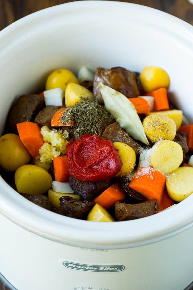 Slow Cooker Beef Stew Recipe | Crockpot Beef Stew #stew #soup #beef #slowcooker #crockpot #dinner #sraye A crock pot filled with beef, vegetables, tomato paste, herbs and spices.