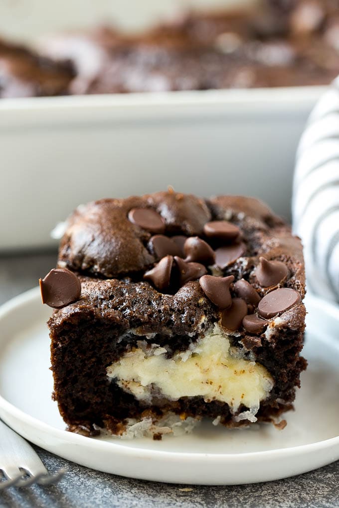 Earthquake Cake Recipe | Chocolate Cake Recipe | Chocolate Coconut Cake | Coconut Pecan Cake #cake #chocolate #coconut #pecans #dessert #chocolatecake #sraye A slice of earthquake cake on a plate.