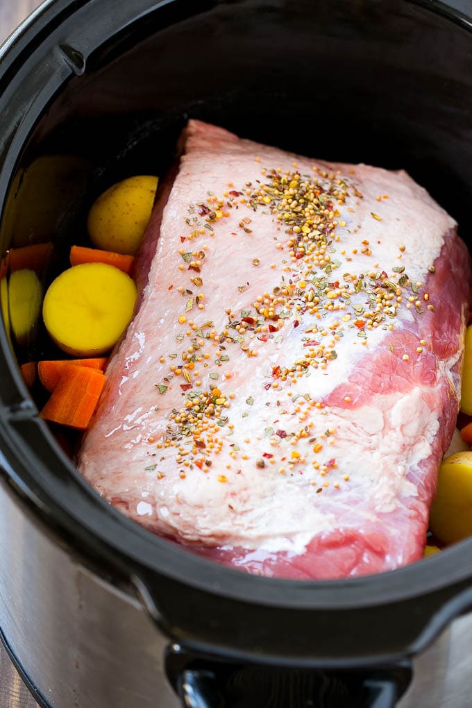 Slow Cooker Corned Beef Recipe | Crock Pot Corned Beef | Corned Beef and Cabbage #beef #cornedbeef #cabbage #potatoes #carrots #stpatricksday #irish #sraye A corned beef roast in a slow cooker with carrots and potatoes.