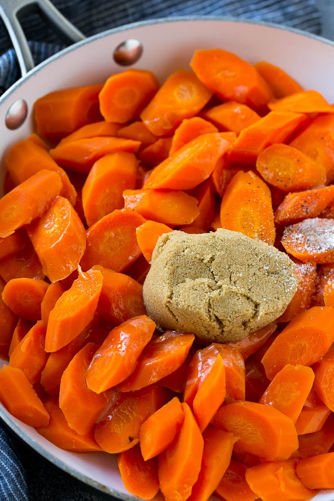 Candied Carrots Recipe | Carrot Side Dish | Brown Sugar Carrots | Glazed Carrots #carrots #brownsugar #sidedish #dinner #sraye Sliced carrots with butter, brown sugar and seasonings in a pan.