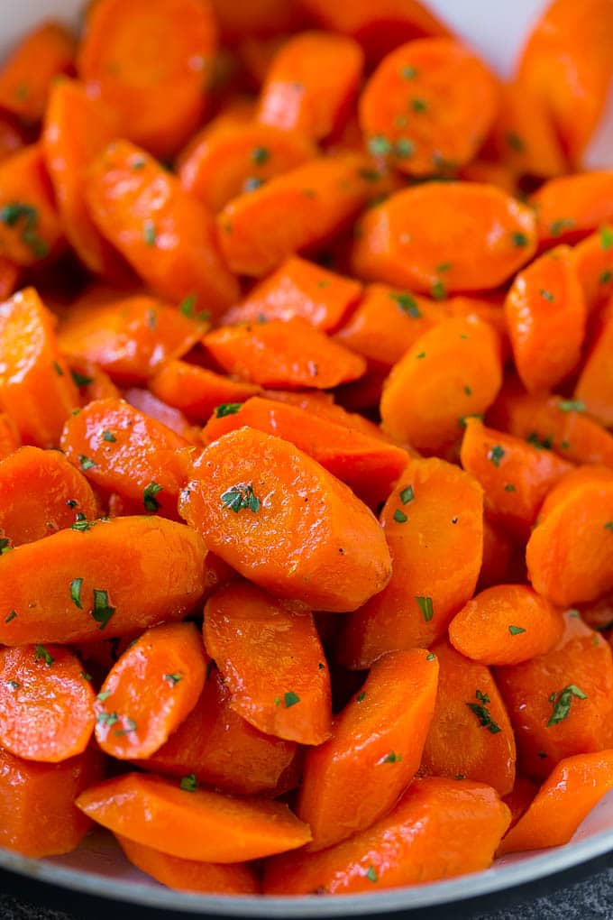Candied Carrots Recipe | Carrot Side Dish | Brown Sugar Carrots | Glazed Carrots #carrots #brownsugar #sidedish #dinner #sraye A close up of cooked candied carrots topped with parsley.