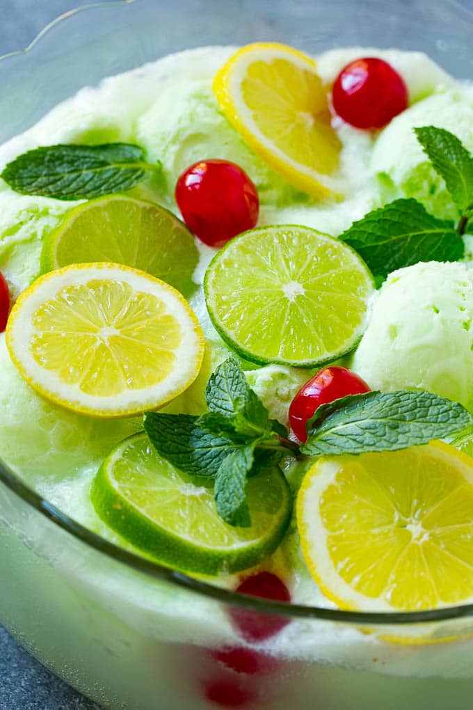 Lime Sherbet Punch | Party Punch Recipe | Sherbet Punch Recipe | Limeade Recipe #sherbet #punch #lime #drink #sraye A close up of a bowl of sherbet punch garnished with citrus and mint.