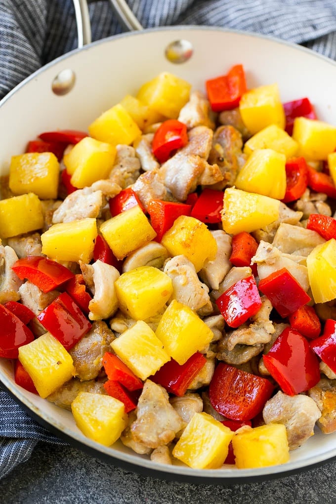 Pineapple Chicken | Hawaiian Chicken | Chicken Stir Fry #pineapple #chicken #dinner #stirfry #sraye A skillet of cooked chicken, pineapple and red bell peppers.