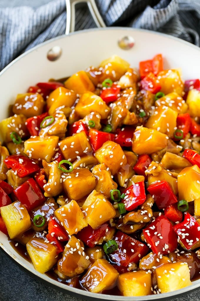 Pineapple Chicken | Hawaiian Chicken | Chicken Stir Fry #pineapple #chicken #dinner #stirfry #sraye Pineapple chicken stir fry in a skillet, topped with sauce, sesame seeds and green onions.