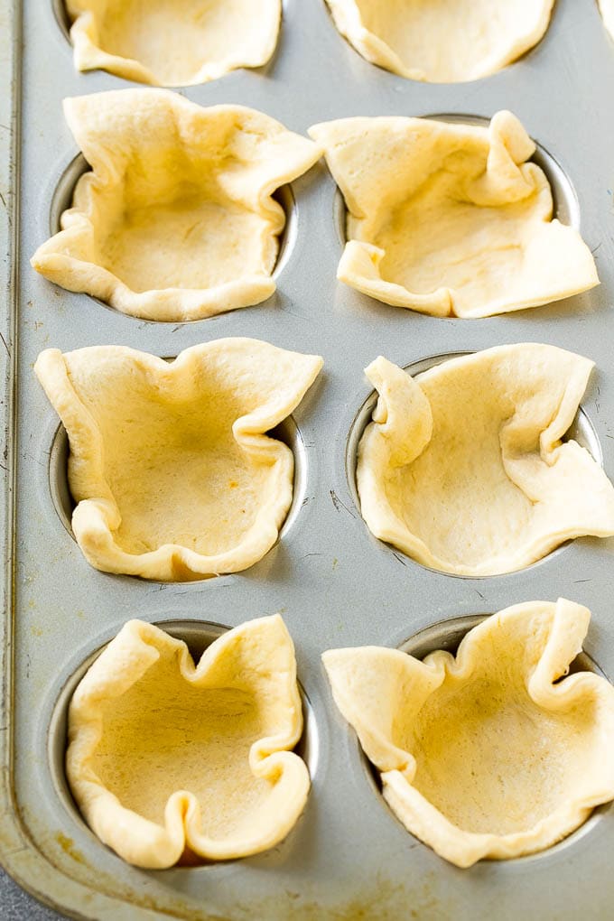 Pizza Muffins Recipe | Pizza Bites | Pizza Cups | Pizza Appetizer #pizza #appetizer #sraye Crescent roll dough pressed into a tin forms the crust.