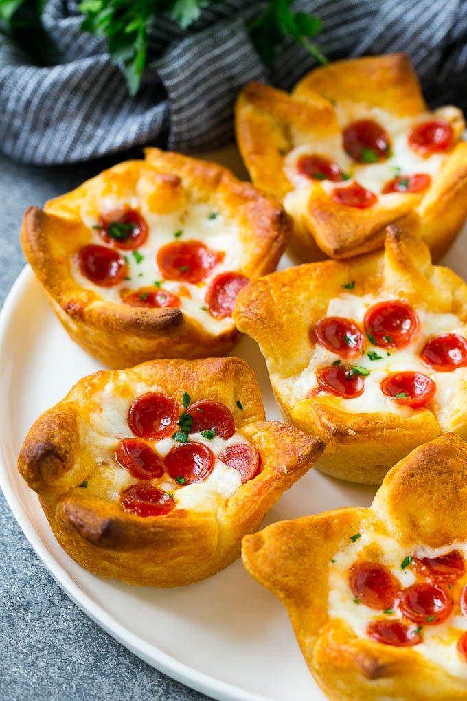 Pizza Muffins Recipe | Pizza Bites | Pizza Cups | Pizza Appetizer #pizza #appetizer #sraye A plate of pizza muffins made with crescent roll dough, pizza sauce, melted cheese and mini pepperoni.