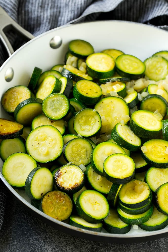 Zucchini Gratin Recipe | Cheesy Zucchini | Baked Zucchini | Easy Zucchini Recipe #zucchini #casserole #cheese #dinner #sidedish #sraye Sauteed zucchini and onions in a skillet.