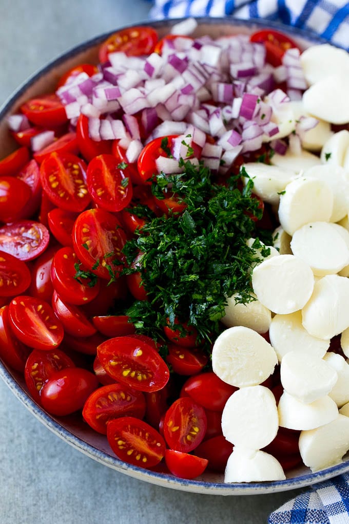 Cherry Tomato Salad Recipe | Tomato Mozzarella Salad | Caprese Salad | Tomato Salad #tomatoes #salad #tomatosalad #caprese #sraye A bowl of halved cherry tomatoes, mozzarella balls, herbs and minced red onion.