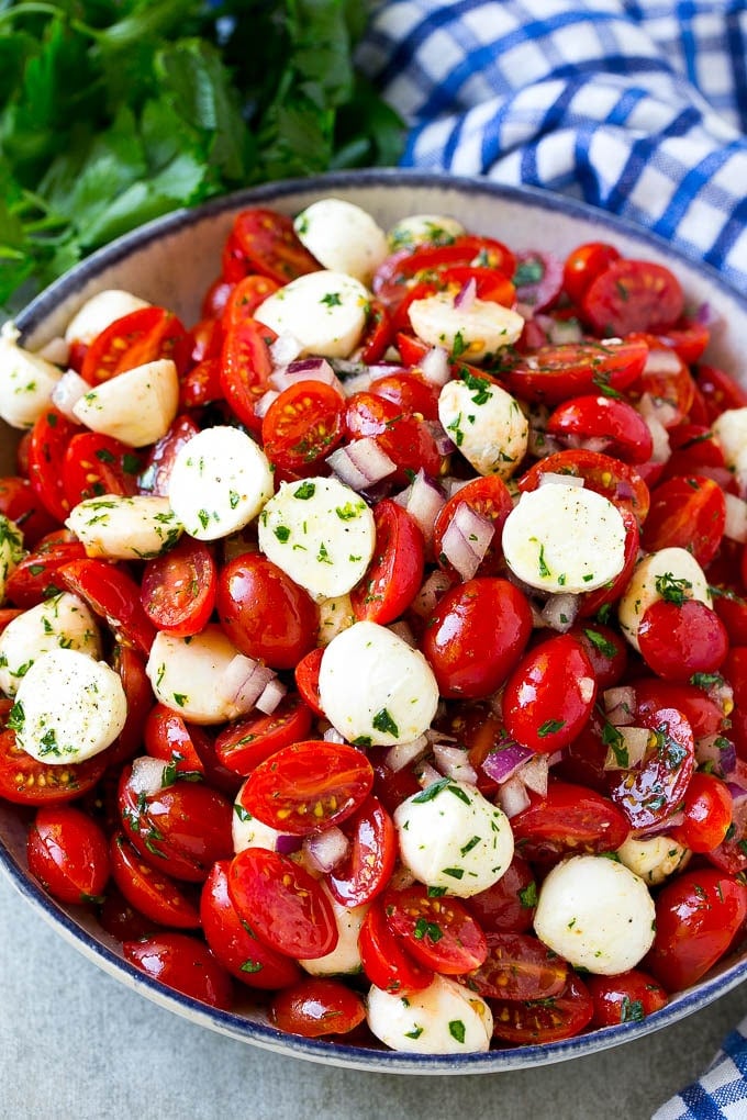 Cherry Tomato Salad Recipe | Tomato Mozzarella Salad | Caprese Salad | Tomato Salad #tomatoes #salad #tomatosalad #caprese #sraye A serving bowl of tomato mozzarella salad with cherry tomatoes, herbs and red onion.