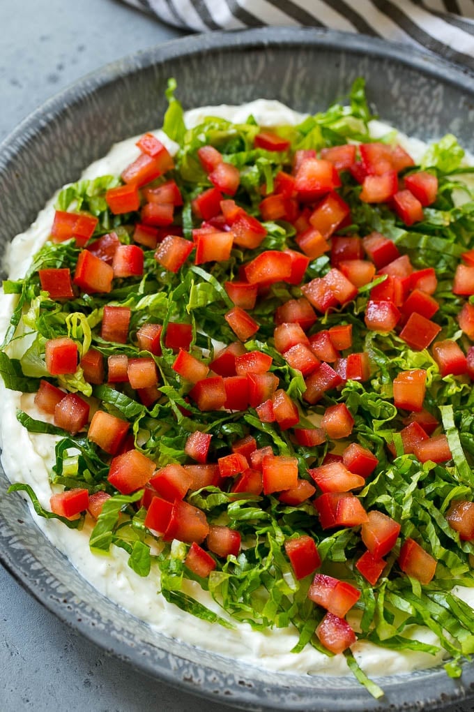 BLT Dip Recipe | Bacon Dip Recipe | Ranch Dip #dip #ranch #bacon #lettuce #tomato #appetizer #sraye Lettuce and tomatoes on top of ranch dip.
