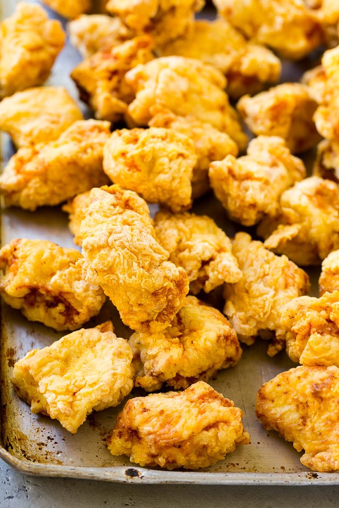 Sweet and Sour Chicken Recipe | Chinese Food Copycat Recipe | Chicken with Pineapple #chicken #chinesefood #pineapple #stirfry #takeout #dinner #sraye Fried pieces of chicken thighs on a sheet pan.