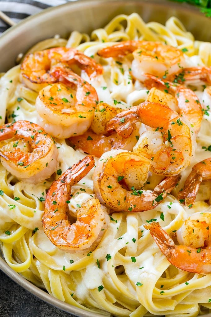 Shrimp Alfredo Recipe | Shrimp Alfredo Pasta | Shrimp Fettuccine Alfredo #shrimp #pasta #italianfood #sraye Shrimp alfredo in a skillet, topped with chopped parsley.