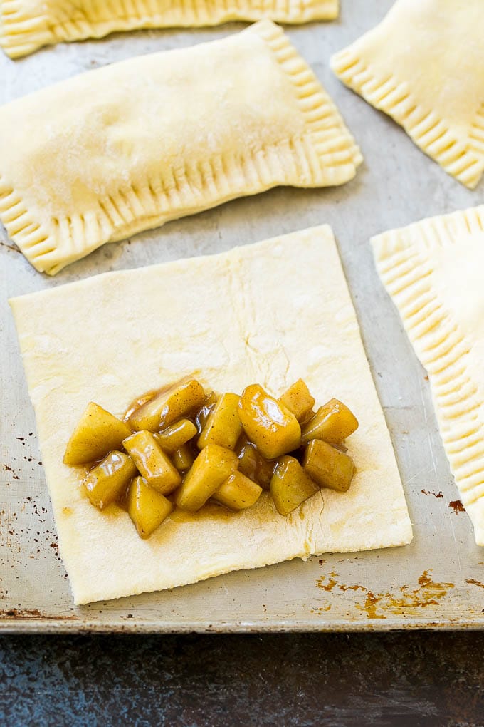 Fried Apple Pies Recipe | McDonald's Copycat Recipe | Apple Pie | Apple Hand Pies #pie #apples #applepie #dessert #snack #sraye A sheet of puff pastry topped with homemade apple pie filling.