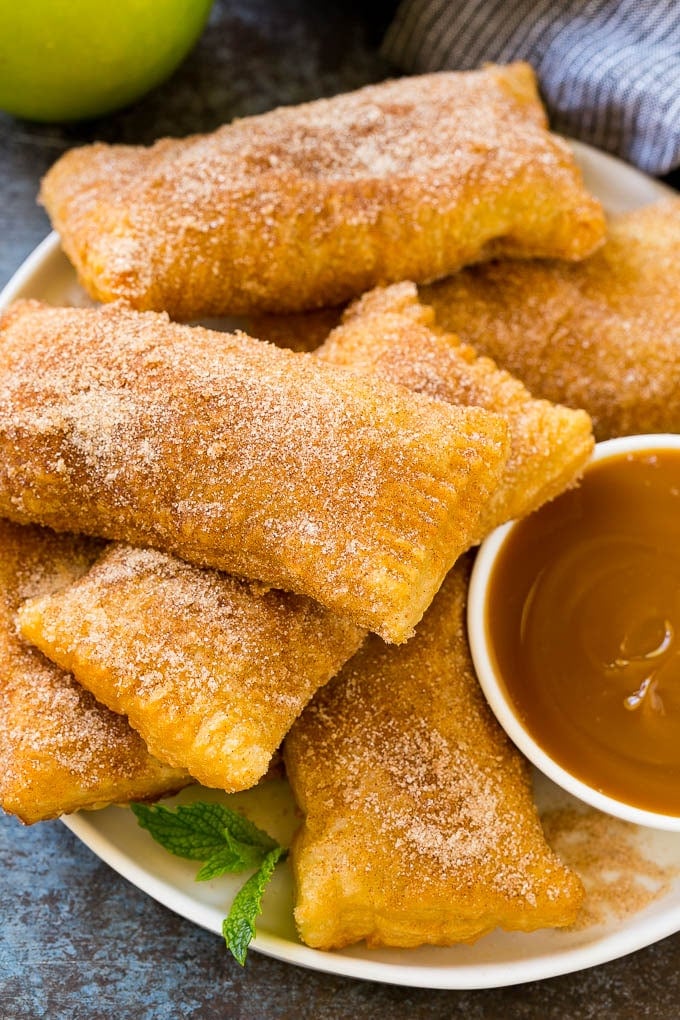 Fried Apple Pies Recipe | McDonald's Copycat Recipe | Apple Pie | Apple Hand Pies #pie #apples #applepie #dessert #snack #sraye A plate of deep fried apple pies dusted with cinnamon sugar.