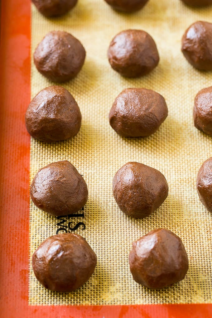Nutella Cookies Recipe | Nutella Stuffed Cookies | Chocolate Cookies #nutella #chocolate #cookies #baking #dessert #sraye Balls of chocolate cookie dough on a baking sheet.