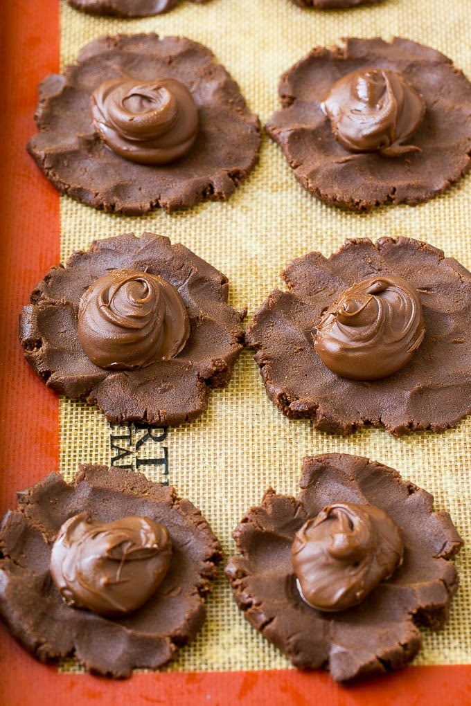 Nutella Cookies Recipe | Nutella Stuffed Cookies | Chocolate Cookies #nutella #chocolate #cookies #baking #dessert #sraye Cookie dough with dollops of nutella in the center.