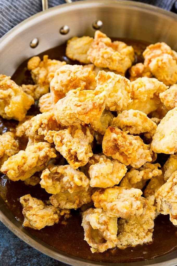 Orange Chicken Recipe | Chinese Orange Chicken | Panda Express Orange Chicken #orange #chicken #takeout #chinesefood #dinner #sraye Crispy chicken pieces in a pan of orange sauce.