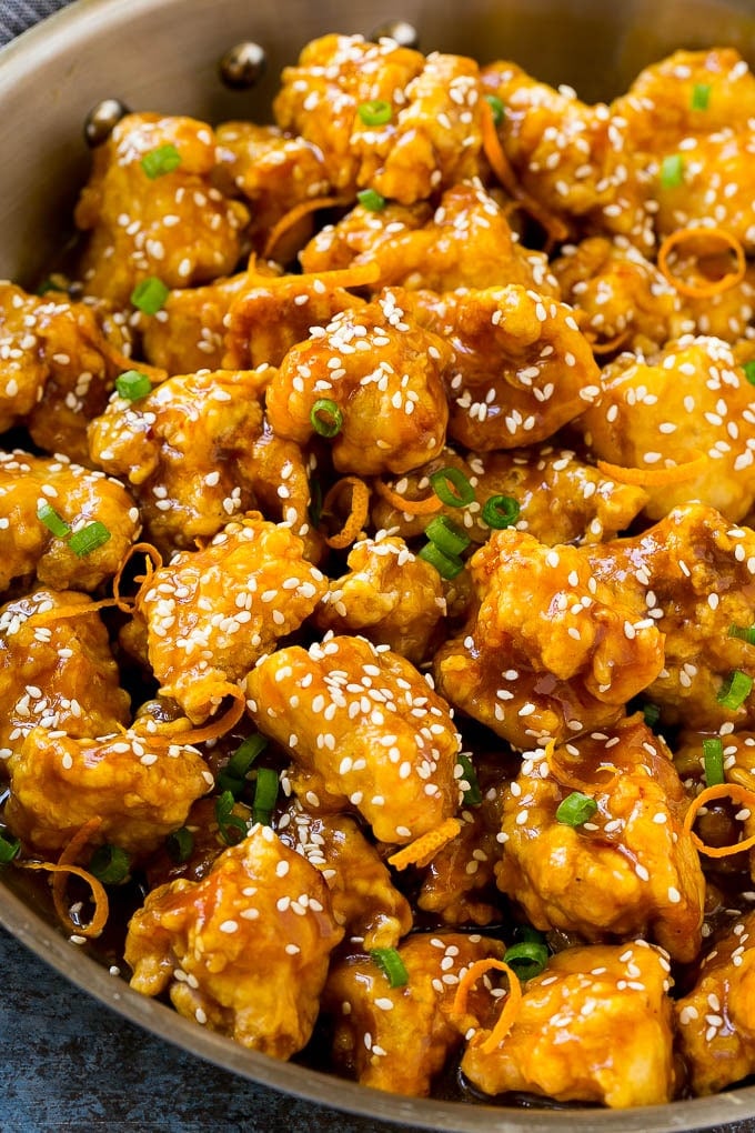 Orange Chicken Recipe | Chinese Orange Chicken | Panda Express Orange Chicken #orange #chicken #takeout #chinesefood #dinner #sraye Orange chicken in a skillet with crispy chicken, sesame seeds, orange zest and green onions.