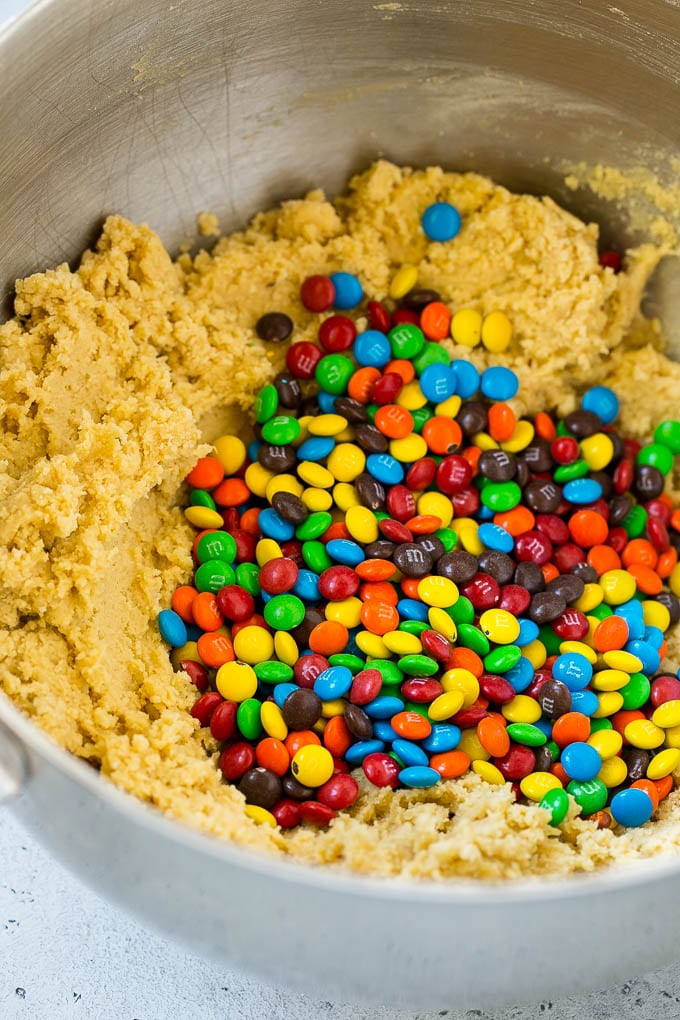 Oreo Stuffed Cookies Recipe | M&M's cookies | Stuffed Cookies #cookies #chocolate #oreos #dessert #baking #sraye Cookie dough in a mixing bowl with miniature M&M's in it.