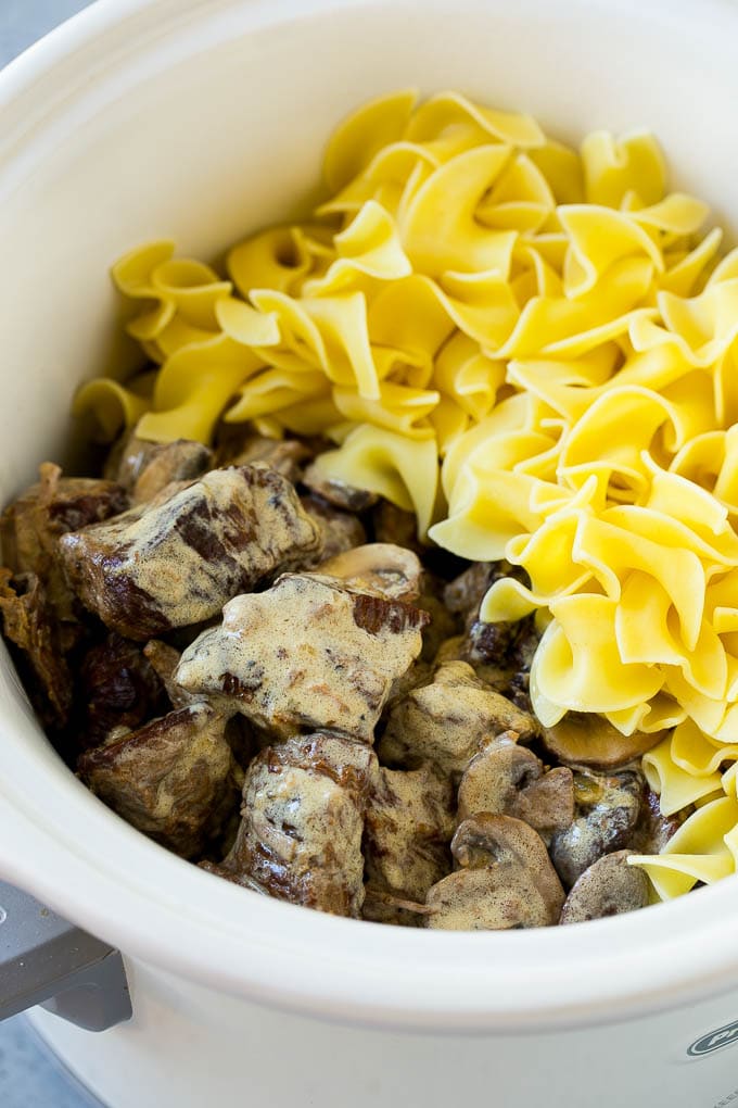 Slow Cooker Beef Stroganoff Recipe | Crock Pot Beef Stroganoff | Beef Recipe #slowcooker #crockpot #beef #mushrooms #pasta #dinner #sraye Beef in a creamy sauce and egg noodles in a slow cooker.