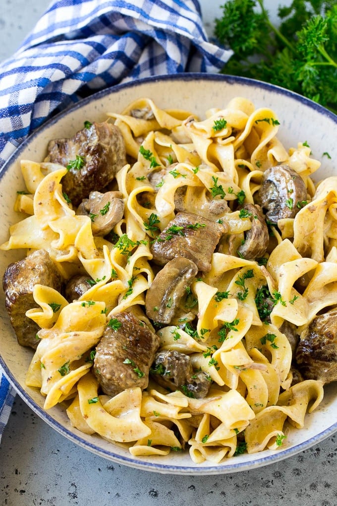 Slow Cooker Beef Stroganoff Recipe | Crock Pot Beef Stroganoff | Beef Recipe #slowcooker #crockpot #beef #mushrooms #pasta #dinner #sraye A bowl of slow cooker beef stroganoff with egg noodles.