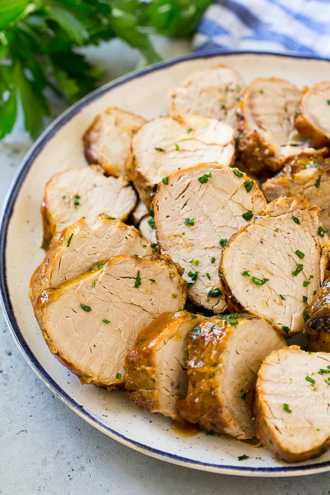 Slow Cooker Pork Tenderloin Recipe | Crock Pot Pork Tenderloin | Easy Pork Tenderloin #slowcooker #crockpot #pork #dinner #sraye Sliced slow cooker pork tenderloin on a plate.
