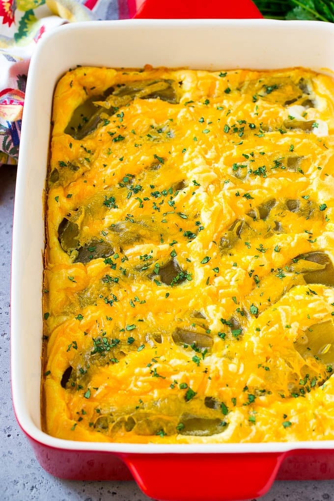 Chile Relleno Casserole Recipe | Baked Chile Rellenos | Mexican Casserole #casserole #chiles #mexican #cheese #dinner #sraye A dish of chile relleno casserole topped with cheddar cheese and chopped cilantro.