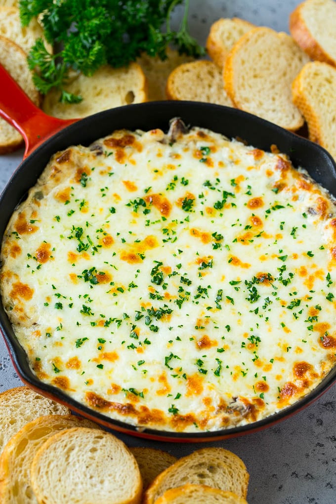 Philly Cheesesteak Dip Recipe | Cheesy Dip | Baked Cheese Dip #steak #dip #appetizer #cheese #sraye A skillet of baked Philly cheesesteak dip with melted cheese and parsley on top.