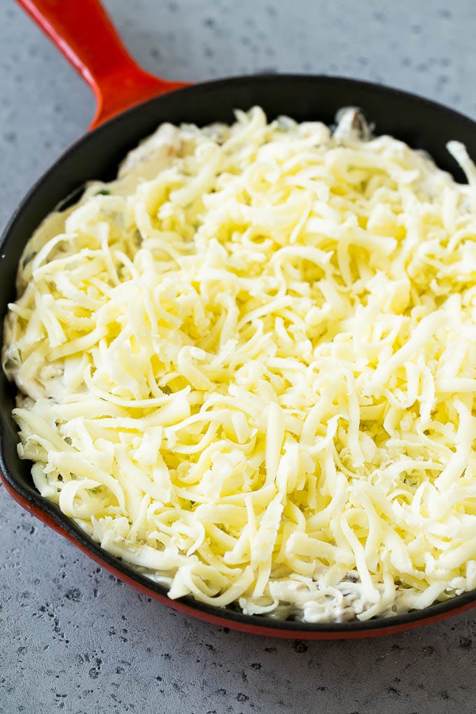 Philly Cheesesteak Dip Recipe | Cheesy Dip | Baked Cheese Dip #steak #dip #appetizer #cheese #sraye Philly cheesesteak dip with shredded cheese on top, waiting to go into the oven.