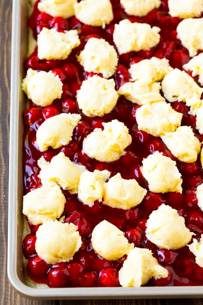 Cherry Bars Recipe | Cherry Pie Bars | Cherry Cookies | Bar Cookies #cookies #bars #cherry #baking #dessert #sweets #sraye Filling with dollops of cookie dough on top.