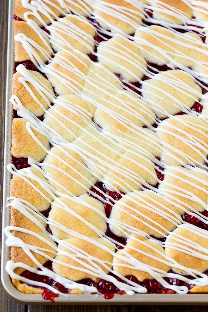 Cherry Bars Recipe | Cherry Pie Bars | Cherry Cookies | Bar Cookies #cookies #bars #cherry #baking #dessert #sweets #sraye Cherry bars topped with vanilla glaze.
