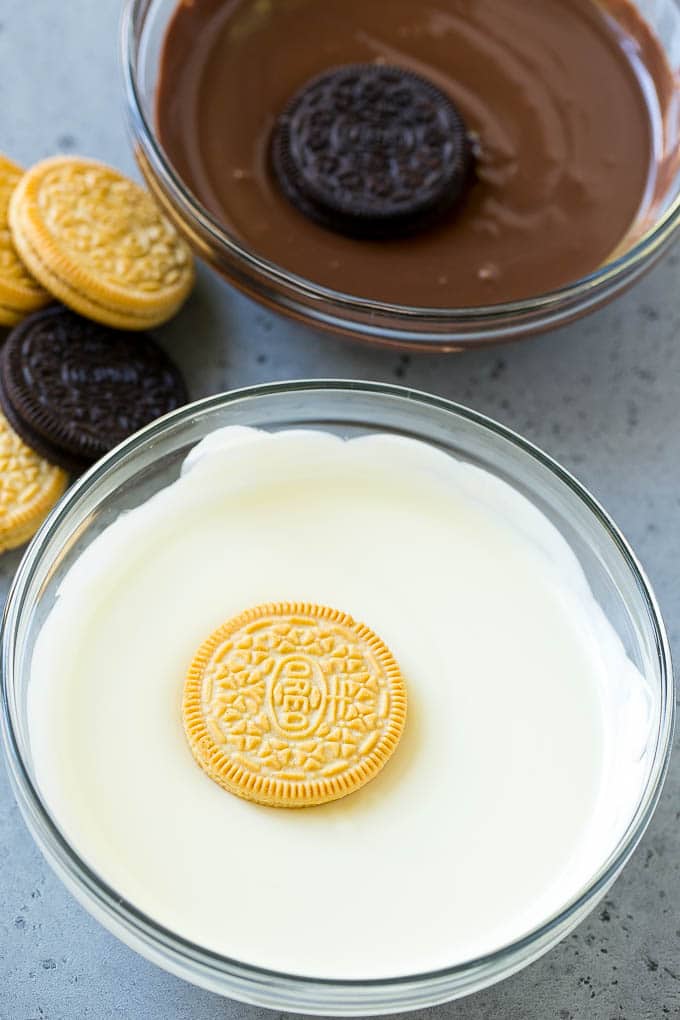 Chocolate Covered Oreos Recipe | Oreo Cookies | Chocolate Dipped Oreos #oreo #cookies #chocolate #sprinkles #dessert #sraye Cookies being dipped into dark and white chocolate.