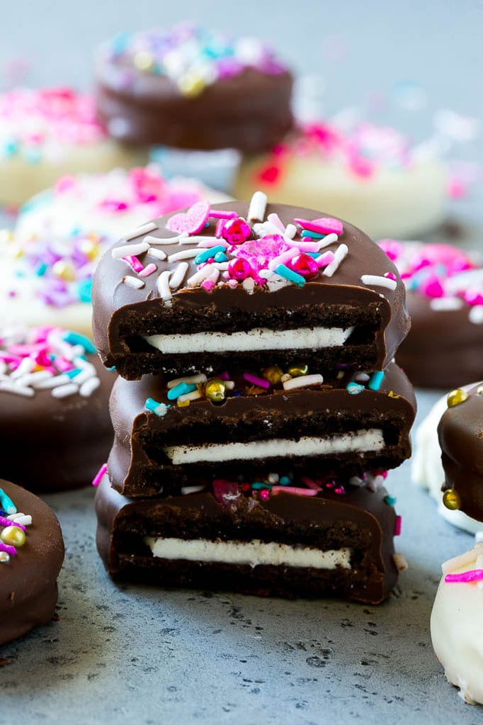 Chocolate Covered Oreos Recipe | Oreo Cookies | Chocolate Dipped Oreos #oreo #cookies #chocolate #sprinkles #dessert #sraye Three chocolate covered Oreos stacked on top of each other.