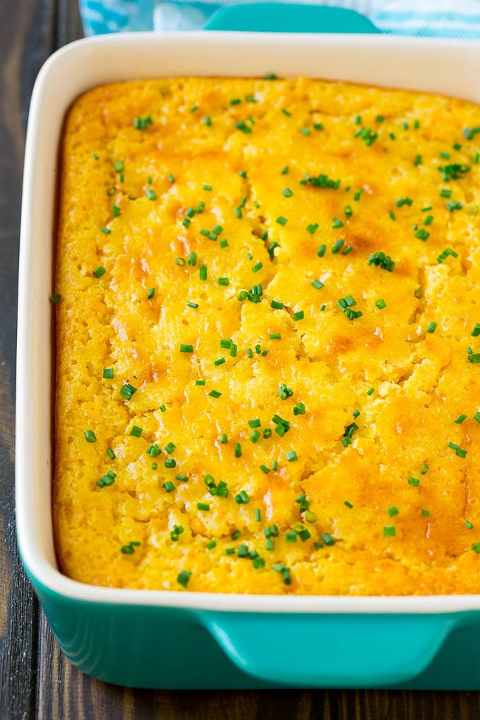 Corn Pudding Recipe | Corn Casserole | Corn Side Dish #corn #pudding #casserole #sidedish #thanksgiving #dinner #sraye A casserole dish of corn pudding topped with chives.