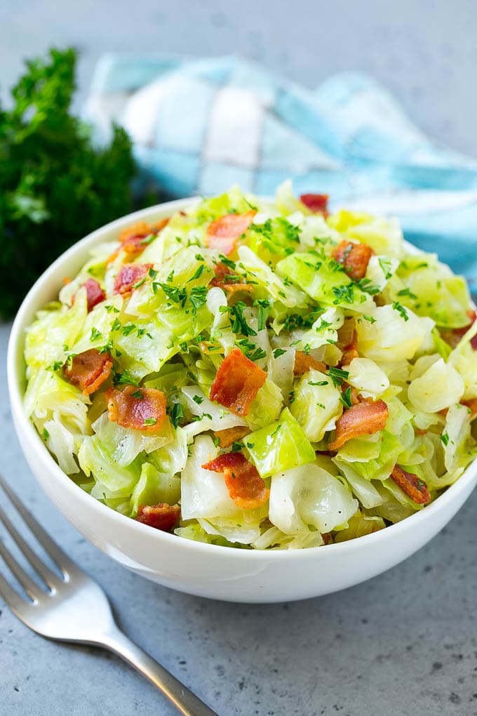 Fried Cabbage Recipe | Cabbage with Bacon | Cabbage Side Dish #cabbage #bacon #sidedish #lowcarb #keto #sraye A bowl of fried cabbage topped with bacon and parsley.
