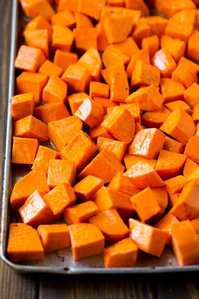Maple Roasted Sweet Potatoes Recipe | Easy Sweet Potatoes | Baked Sweet Potatoes | Sweet Potato Side Dish #sweetpotatoes #cinnamon #maple #butter #fall #sidedish #dinner #sraye Raw diced sweet potatoes on a sheet pan, ready to go into the oven.