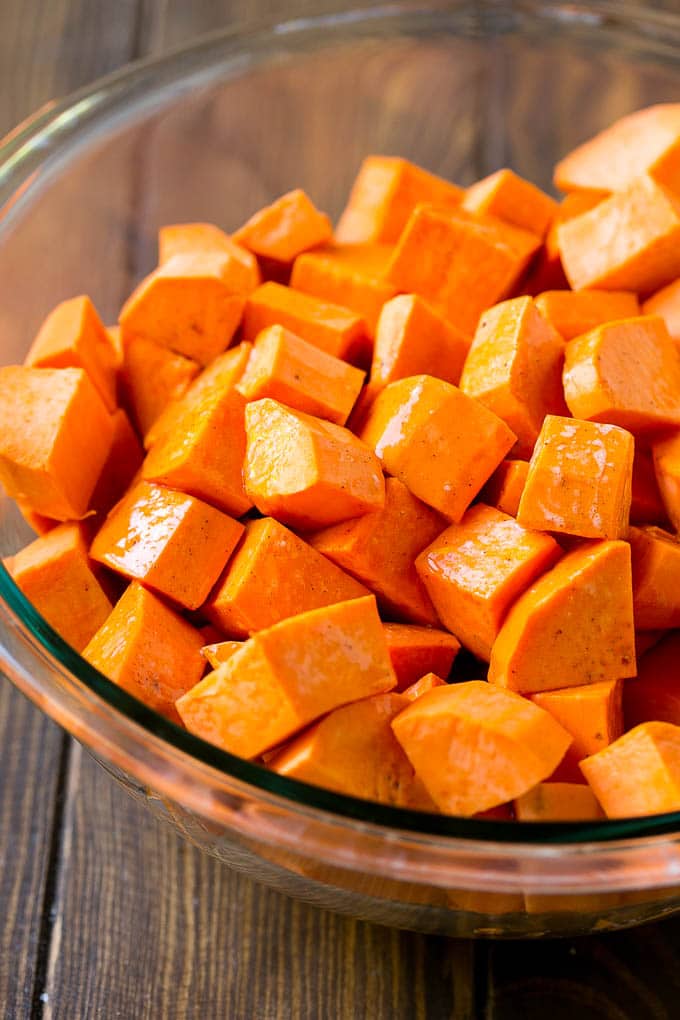 Maple Roasted Sweet Potatoes Recipe | Easy Sweet Potatoes | Baked Sweet Potatoes | Sweet Potato Side Dish #sweetpotatoes #cinnamon #maple #butter #fall #sidedish #dinner #sraye A bowl of peeled and diced yams.