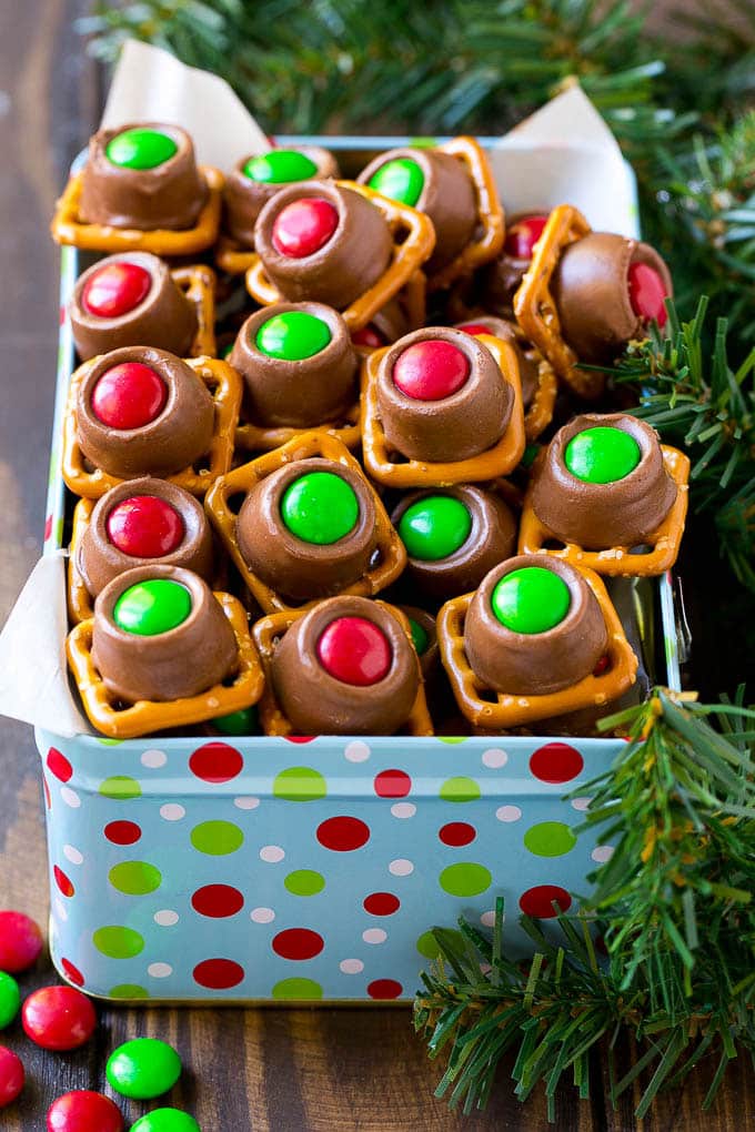 Rolo Pretzels Recipe | Chocolate Pretzels | Caramel Pretzels | Holiday Candy #christmas #baking #dessert #candy #chocolate #caramel #pretzels #sraye A gift tin full of Christmas colored Rolo pretzels.