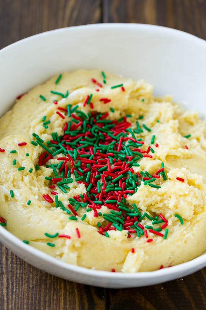 Cake Mix Cookies Recipe | Sprinkle Cookies | Christmas Cookies #cookies #christmas #sprinkles #dessert #baking #sraye A bowl of dough with sprinkles on top.