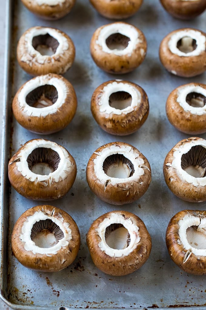 Crab Stuffed Mushrooms Recipe | Stuffed Mushrooms | Mushroom Appetizer #crab #seafood #mushrooms #lowcarb #appetizer #sraye Cremini mushroom caps on a sheet pan.