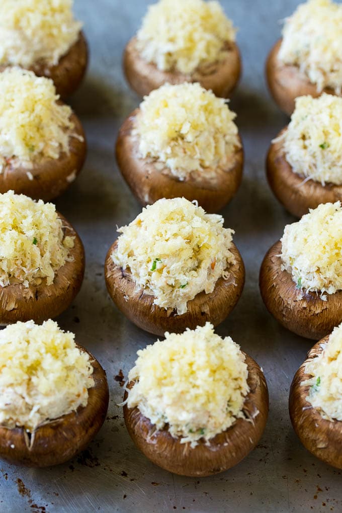Crab Stuffed Mushrooms Recipe | Stuffed Mushrooms | Mushroom Appetizer #crab #seafood #mushrooms #lowcarb #appetizer #sraye Uncooked crab stuffed mushrooms on a sheet pan.