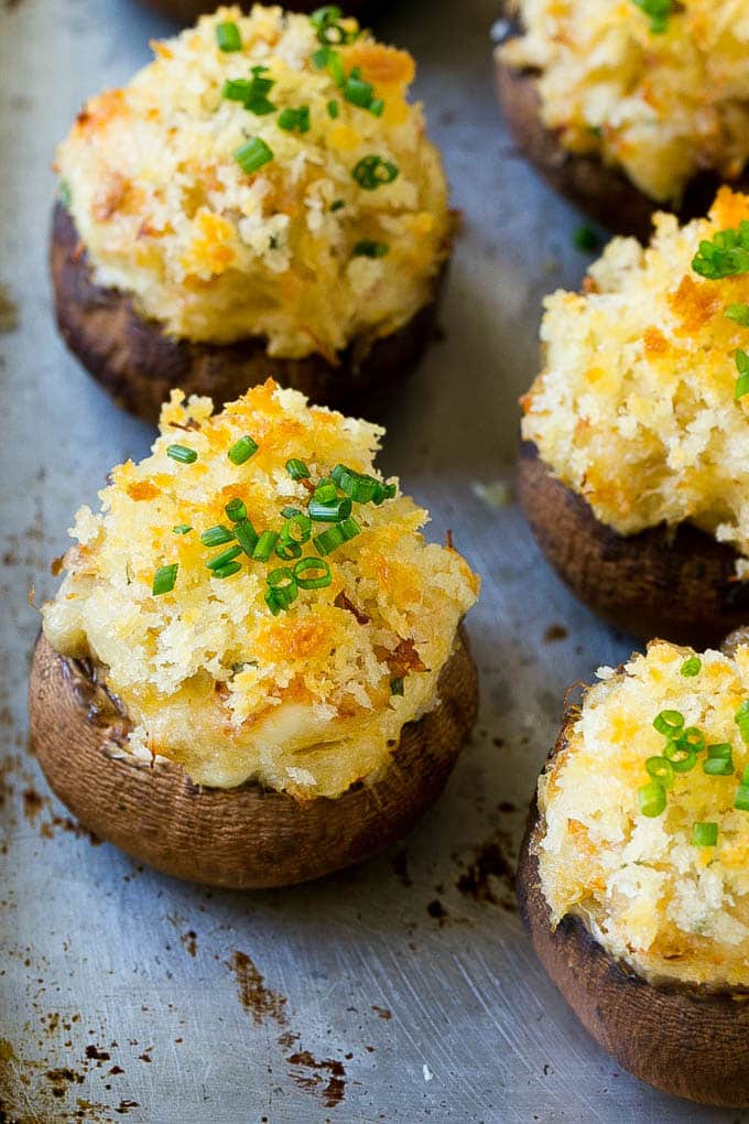 Crab Stuffed Mushrooms Recipe | Stuffed Mushrooms | Mushroom Appetizer #crab #seafood #mushrooms #lowcarb #appetizer #sraye Crab stuffed mushrooms on a sheet pan topped with sliced chives.