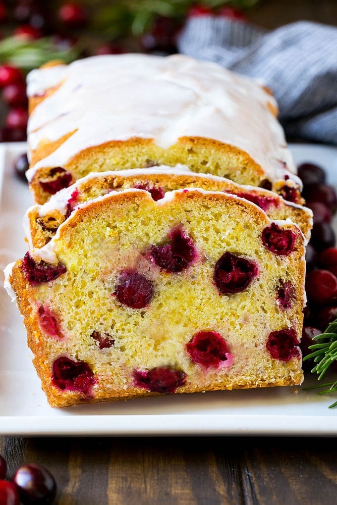 Cranberry Bread Recipe | Cranberry Loaf | Cranberry Orange Bread #cranberry #bread #baking #dessert #fall #sraye Sliced cranberry bread on a serving plate.